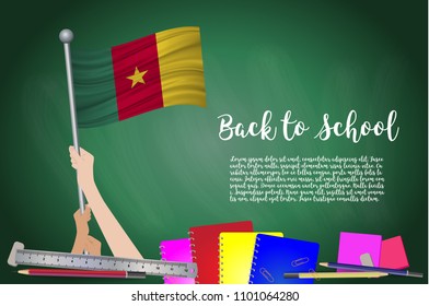 Vector flag of cameroon on Black chalkboard background. Education Background with Hands Holding Up of cameroon flag. Back to school with pencils, books, school items learning and childhood concept.