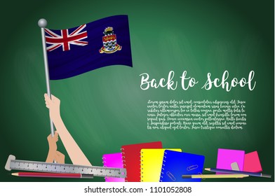 Vector flag of Cayman Islands on Black chalkboard background. Education Background with Hands Holding Up of Cayman Islands flag. Back to school with pencils, books, school items learning and childhood