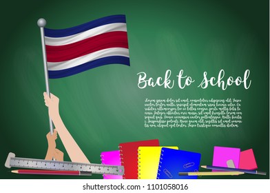 Vector flag of Costa Rica on Black chalkboard background. Education Background with Hands Holding Up of Costa Rica flag. Back to school with pencils, books, school items learning and childhood concept