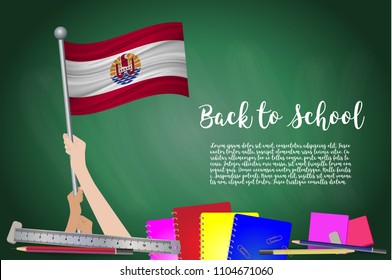 Vector flag of French Polynesia on Black chalkboard background. Education Background with Hands Holding Up of French Polynesia flag. Back to school with pencils, books, school items learning