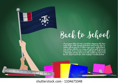 Vector flag of French Southern on Black chalkboard background. Education Background with Hands Holding Up of French Southern flag. Back to school with pencils, books, school items learning