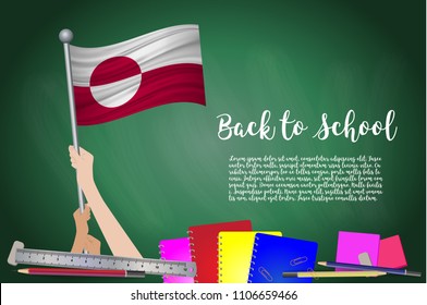 Vector flag of Greenland on Black chalkboard background. Education Background with Hands Holding Up of Greenland flag. Back to school with pencils, books, school items learning and childhood concept.