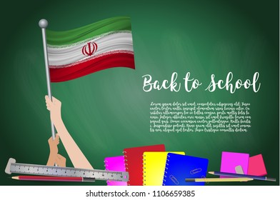 Vector flag of Iran on Black chalkboard background. Education Background with Hands Holding Up of Iran flag. Back to school with pencils, books, school items learning and childhood concept.
