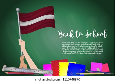 Vector flag of Latvia on Black chalkboard background. Education Background with Hands Holding Up of Latvia flag. Back to school with pencils, books, school items learning and childhood concept.