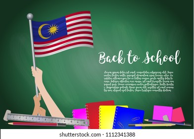 Vector flag of Malaysia on Black chalkboard background. Education Background with Hands Holding Up of Malaysia flag. Back to school with pencils, books, school items learning and childhood concept.