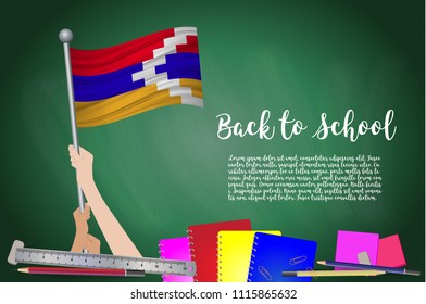 Vector flag of Nagorno Karabakh on Black chalkboard background. Education Background with Hands Holding Up of Nagorno Karabakh flag. Back to school with pencils, books, school items learning