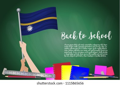 Vector flag of Nauru on Black chalkboard background. Education Background with Hands Holding Up of Nauru flag. Back to school with pencils, books, school items learning and childhood concept.
