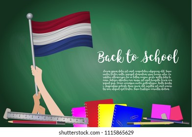 Vector flag of Netherlands on Black chalkboard background. Education Background with Hands Holding Up of Netherlands flag. Back to school with pencils, books, school items learning and childhood