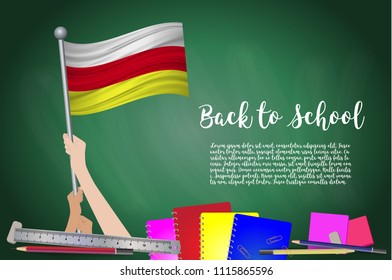 Vector flag of North Ossetia on Black chalkboard background. Education Background with Hands Holding Up of North Ossetia flag. Back to school with pencils, books, school items learning and childhood 
