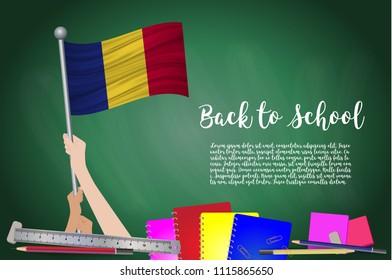 Vector flag of Romania on Black chalkboard background. Education Background with Hands Holding Up of Romania flag. Back to school with pencils, books, school items learning and childhood concept.