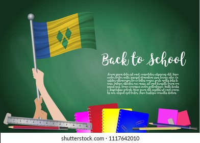 Vector flag of Saint Vincent and the Grenadines on Black chalkboard background. Education Background with Hands Holding Up of Saint Vincent and the Grenadines flag. Back to school with pencils, books