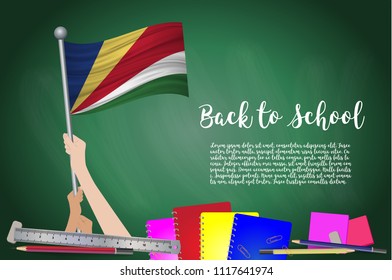 Vector flag of Seychelles on Black chalkboard background. Education Background with Hands Holding Up of Seychelles flag. Back to school with pencils, books, school items learning and childhood concept