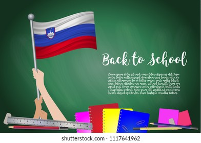 Vector flag of Slovenia on Black chalkboard background. Education Background with Hands Holding Up of Slovenia flag. Back to school with pencils, books, school items learning and childhood concept.