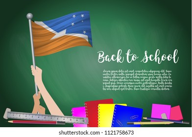 Vector flag of Tierra del Fuego Province on Black chalkboard background. Education Background with Hands Holding Up of Tierra del Fuego Province flag. Back to school with pencils, books, school items