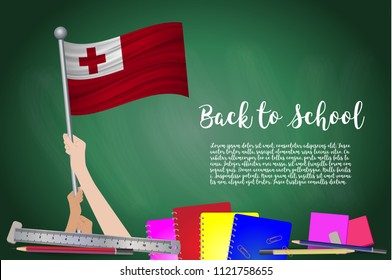 Vector flag of Tonga on Black chalkboard background. Education Background with Hands Holding Up of Tonga flag. Back to school with pencils, books, school items learning and childhood concept.