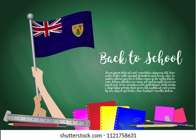 Vector flag of Turks and Caicos on Black chalkboard background. Education Background with Hands Holding Up of Turks and Caicos flag. Back to school with pencils, books, school items learning