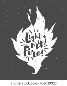 Vector flame with lettering and grunge texture. Light my fire. Burning bonfire silhouette with motivation quote and sparks. Illustration or background with space for your text.