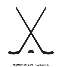Vector flat black hockey crossed sticks and puck isolated on white background