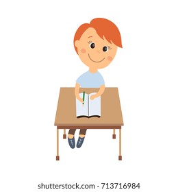 vector flat cartoon cute schoolboy character sitting at desk in elementary school smiling. Isolated illustration on a white background. Child education, back to school concept