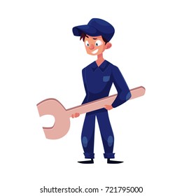 vector flat cartoon funny young man, boy mechanic in blue uniform holding big wrench in hands smiling. Male full lenght portrait caucasian character isolated, illustration on a white background.