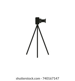 vector flat cartoon lens photo camera standing at special tripod stand side view. Professional photo equipment. Isolated illustration on a white background.
