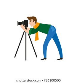 vector flat cartoon man in casual clothing wearing scarf, jeans making shoots by dslr photo camera standing on tripod. Isolated illustration on a white background.