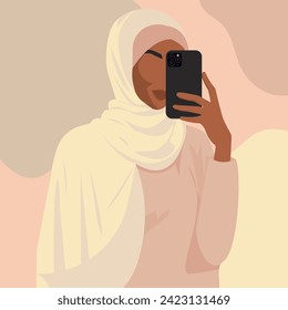 Vector flat fashion illustration of a beautiful elegant Muslim girl in hijab with a smartphone in her hand.
