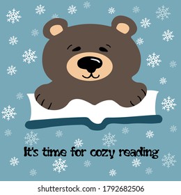 
Vector flat illustration of a cartoon bear, reading a book. On a blue background with flakes of snow and the inscription: It’s time for cozy reading. New-year/ Christmas card, print, web