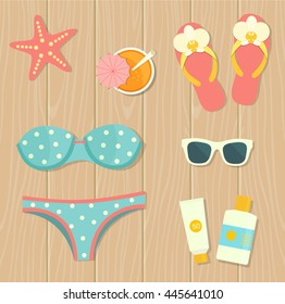 Vector flat illustration of flip flops, sunglasses and bikini on the wooden background , top view. 