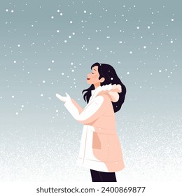 Vector flat illustration of a young girl in a warm jacket catching snowflakes. Cozy winter season.
