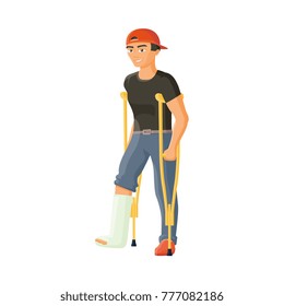 Vector Flat Man With Broken Leg In Plaster Cast. Young Adult Male Disabled Character In Denim Jeans, Red Cap Standing On Crutches Smiling. Isolated Illustration On A White Background.