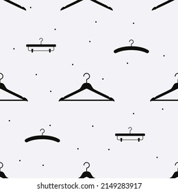 Vector flat silhouette hand drawn seamless pattern with hangers 