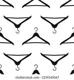 Vector flat silhouette hand drawn seamless pattern with hangers 