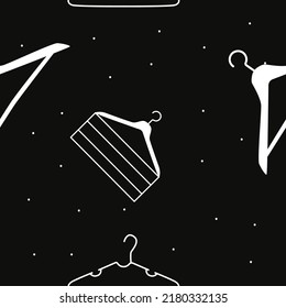 Vector flat silhouette hand drawn seamless pattern with hangers 