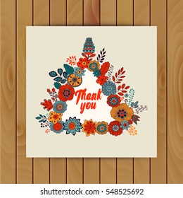 Vector floral card made of flowers in triangle shape. Wedding invitation. Frame for logo, label or greetings. Doodle floral design. Flowers design with place for your message