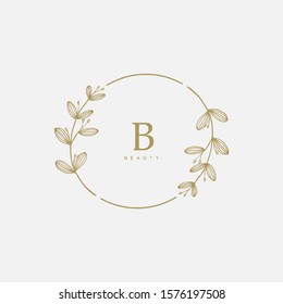 Vector floral hand drawn logo template in elegant and minimal style with gold color on grey background illustration. Circle frames logos. For badges, labels, logotypes and branding business identity.