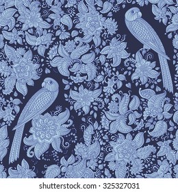 Vector floral seamless pattern. Exotic bird with fantastic flowers, leaves. Light blue grey fairy parrot silhouette in the jungle on a dark indigo background. Textile folk print. Batik painting