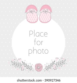 Vector frame for a photo with baby booties and floral design elements. Background polka dot pattern. Scrapbooking album page.