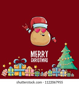 vector funky comic cartoon cute brown smiling santa claus potato with red santa hat, gifts, tree and calligraphic merry christmas text isolated on red background. vegetable funky christmas character