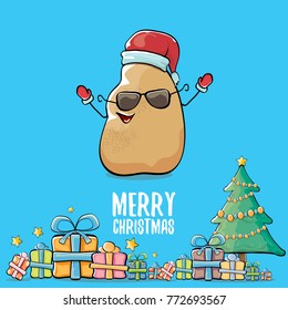 vector funky comic cartoon cute brown smiling santa claus potato with red santa hat, gifts, tree and calligraphic merry christmas text isolated on blue background. vegetable funky christmas character