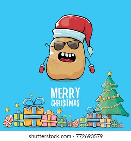 vector funky comic cartoon cute brown smiling santa claus potato with red santa hat, gifts, tree and calligraphic merry christmas text isolated on blue background. vegetable funky christmas character