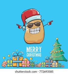 vector funky comic cartoon cute brown smiling santa claus potato with red santa hat, gifts, tree and calligraphic merry christmas text isolated on blue background. vegetable funky christmas character