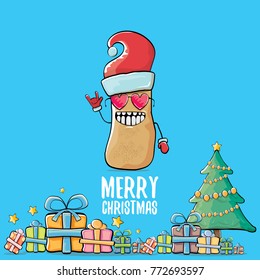vector funky comic cartoon cute brown smiling santa claus potato with red santa hat, gifts, tree and calligraphic merry christmas text isolated on blue background. vegetable funky christmas character