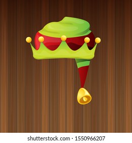 vector funky red and green stripped cartoon christmas elf hat isolated on wooden background. vector kids colorful elf hat icon or label. Christmas decorative design element for banner, flyer or poster