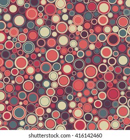 Vector geometric background. The round elements of various sizes and colors are placed on red.