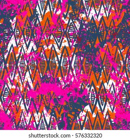 Vector geometric pattern over colorful watercolor splash. Bold hand drawn chevron pattern for sport fashion with ethnic, tribal motif. Seamless modern grunge striped background with zigzag line stripe