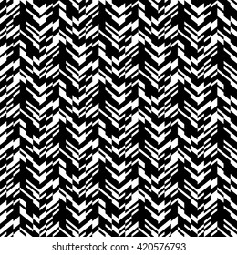 Vector geometric seamless chevron pattern with zigzag line and overlapping stripes in black and white. Striped bold print in hipster style for winter fall fashion. Abstract monochrome tech background