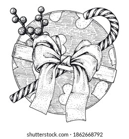 Vector gift of a round shape with a large bow and decorations. Festive box with a beautiful ribbon, candy cane and balls. Hand-drawn sketch. Vintage style engraving. Monochrome illustration, top view