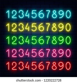 Vector glowing neon blue yellow red green pueple numbers set at dark brick wall background. Bar, pub signage design elements, elluminated electric numerical elements collection illustration