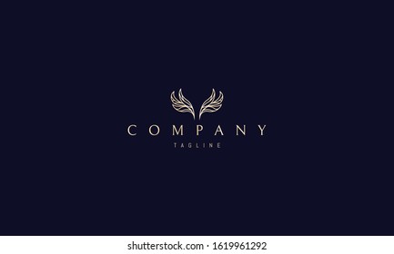 Vector golden logo on which an abstract image of wings in the form of leaves.